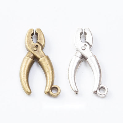 Small pliers-shaped charms with curved handles and a top loop arranged together on a white background.