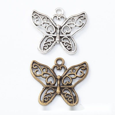 Openwork Floral Butterfly Charm Pendant finish comparison showing scrolling floral cutouts across both wings