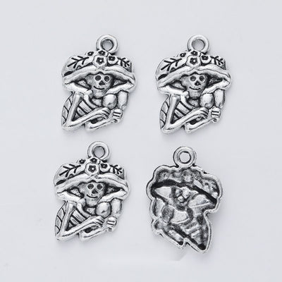 Front view of floral-hat skeleton figure charm showing finish variation 1