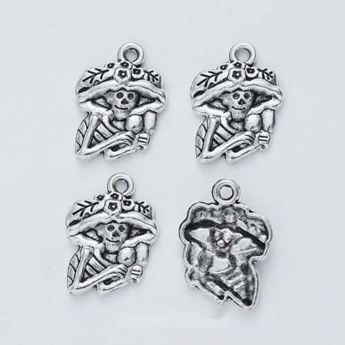 Front view of floral-hat skeleton figure charm showing finish variation 1
