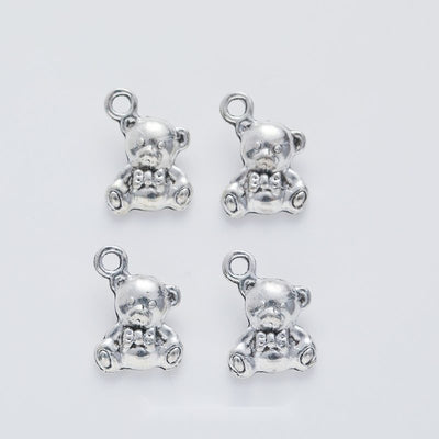 Front-facing arrangement of teddy bear charms on a white background