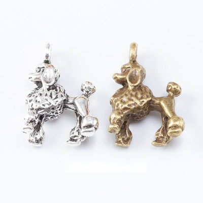 Standing dog charms with curled tails and textured coats arranged together on a white background.