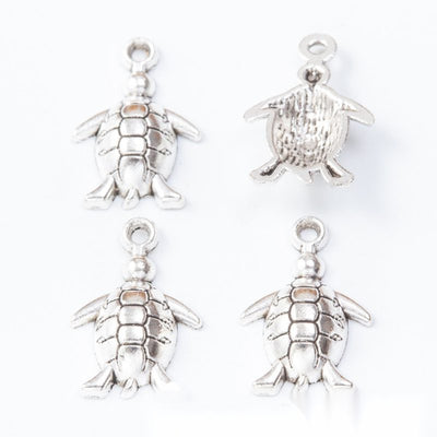 Group view of the sea turtle charm showing the available finishes and front details