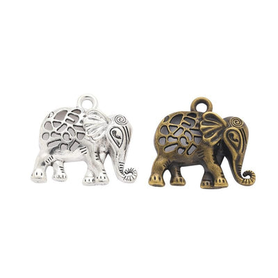 Grouped front views of the floral cutout elephant charm in two antique finishes