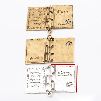 Open Storybook Charm assortment showing the available metal finishes