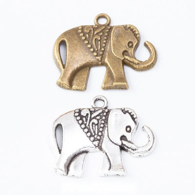 Assorted decorated elephant charms arranged together on a white background