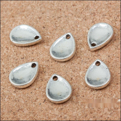 Smooth Teardrop Metal Charms in Antique Silver in antique silver displayed together on a white background.