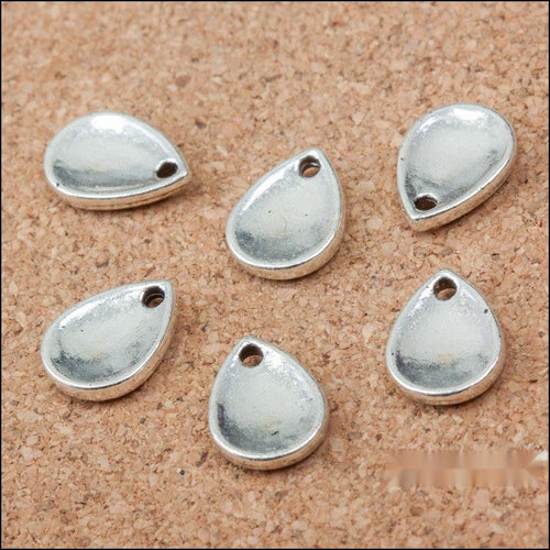 Smooth Teardrop Metal Charms in Antique Silver in antique silver displayed together on a white background.