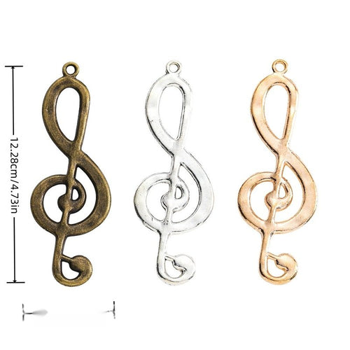 Treble clef charm shown in grouped front views