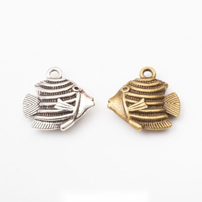 Grouped front view of tropical fish charm showing raised stripes, fins, and a top loop