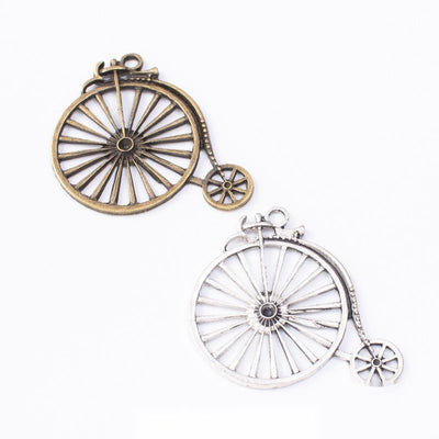 Group view of the penny-farthing bicycle charm showing the available finishes and front details