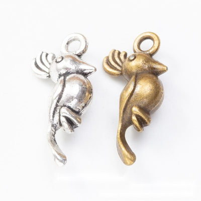 Grouped front views of the long tailed bird metal charm in two antique finishes
