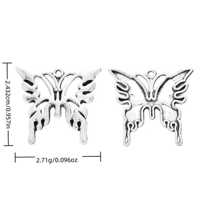 Overview of openwork butterfly charm pieces on a white background