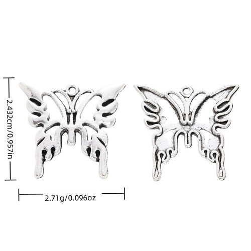 Overview of openwork butterfly charm pieces on a white background