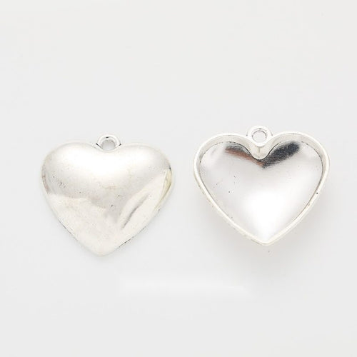 Front and hollow reverse views of the smooth silver-tone heart charm