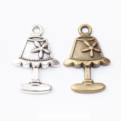 Table Lamp Charm Pendant finish comparison showing a pleated shade, bow detail, and pedestal base