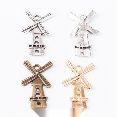 Assorted windmill charms arranged together on a white background