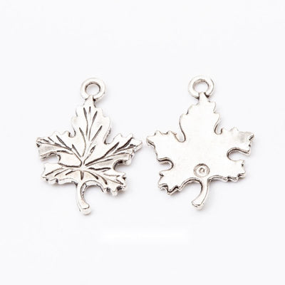 Front comparison of detailed maple leaf metal component in 1 finishes