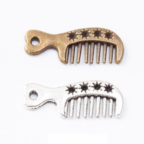 Assorted detailed comb charm pendants displayed together on a white background