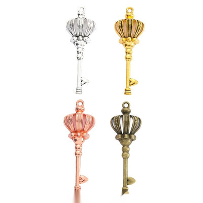 Crown Top Skeleton Key Metal Charms in Four Finishes in multiple metallic finishes displayed together on a white backgro