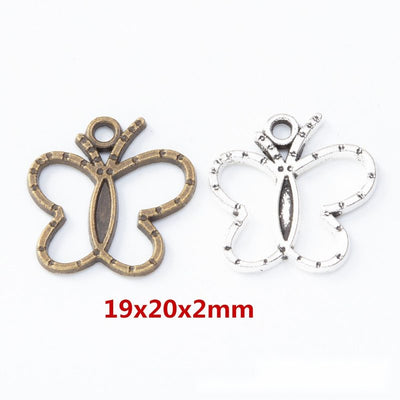 Product view of open butterfly charm showing an open butterfly outline with a long central body, dotted edging, and a to