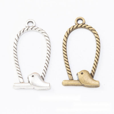 Birdcage And Perched Bird Metal Charm Pendant shown in the available visible finishes