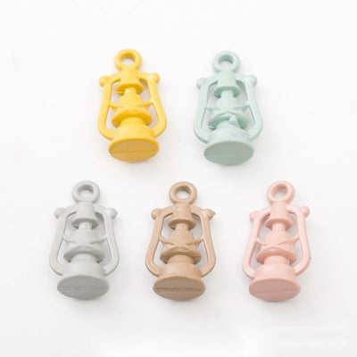 Grouped front view of pastel lantern charms in the available finishes