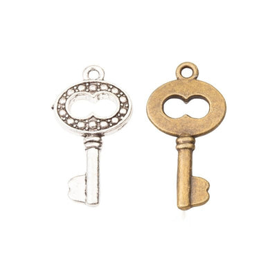 Product view of skeleton key charm showing a skeleton key with an oval bow, dotted border, short bit, and top loop