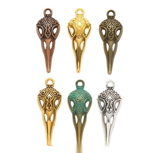 Overview of the ornate bird skull charm in the available metal finishes