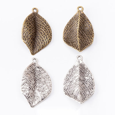 Textured Curved Leaf Charm finish comparison on a white background