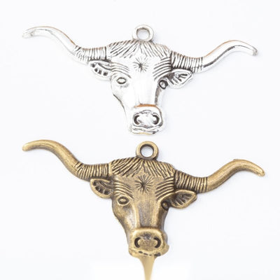 Longhorn cattle head metal component, grouped front view on white
