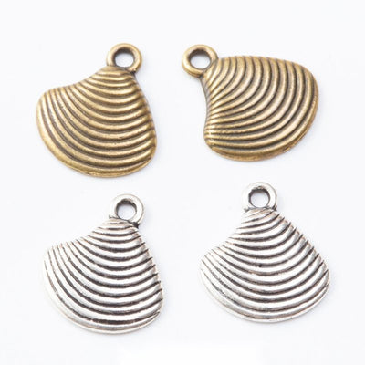 Clam shell charms with ridged fronts and recessed backs arranged together on a white background.