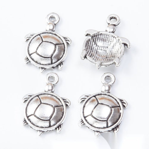 Round turtle connectors with open shell rings and lower hanging loops arranged together on a white background.