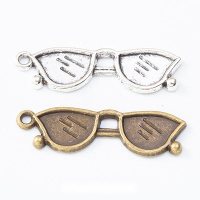 Sunglasses Charm Pendant finish comparison showing a cat-eye frame with textured lenses