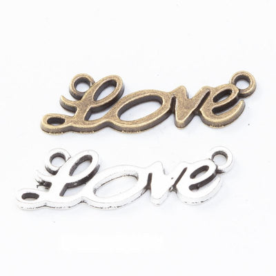 Grouped front views of the script love double loop connector in two antique finishes