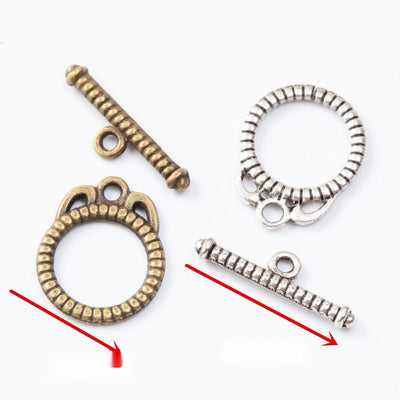 Round ridged toggle rings paired with textured bars arranged together on a white background.