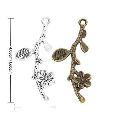 Assorted flowering branch charms arranged together on a white background