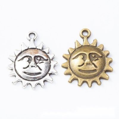 Grouped front view of sun face charms in the available finishes