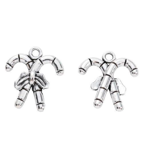 Front-facing arrangement of crossed candy canes charms on a white background