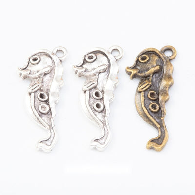 Curled seahorse profile with raised circular details shown in the available finishes
