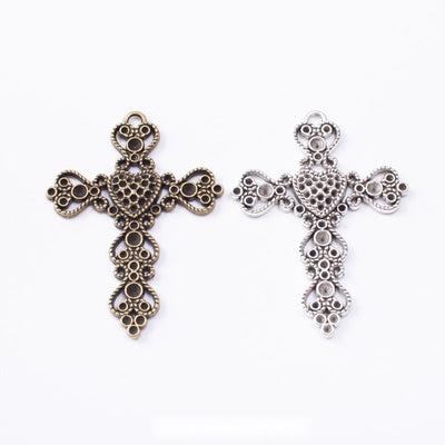 Ornate cross charm shown across the available finishes