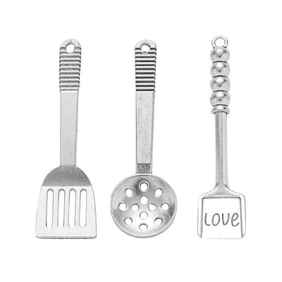 Silver-tone slotted spatula, perforated spoon, and LOVE spatula charms