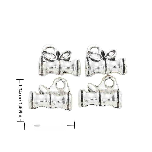 Grouped front views of the graduation cap and open book charm in available finishes