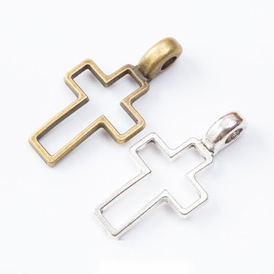 Grouped front view of outline cross pendant showing a hollow center and broad integrated bail