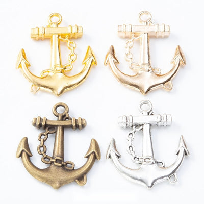Grouped front view of anchor charm showing a wrapped crossbar, short chain, and pointed flukes