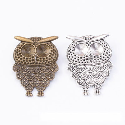 Group view of ornate wide wing owl charm on a white background