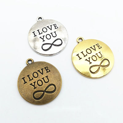 I Love You Infinity Disc metal piece shown in Antique Bronze, Antique Gold, Antique Silver