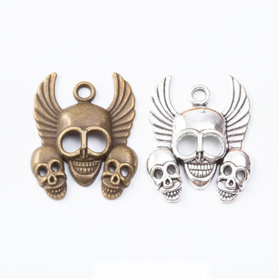 Winged open-jaw skull with two smaller skulls shown across the available finishes