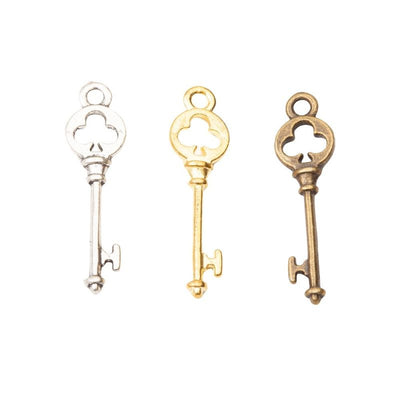 Clover Key Charm grouped finish options on a white background