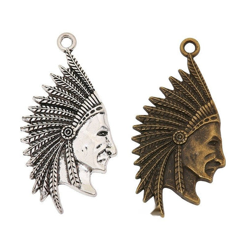 Assorted antique bronze and antique silver headdress portrait charm pieces on white
